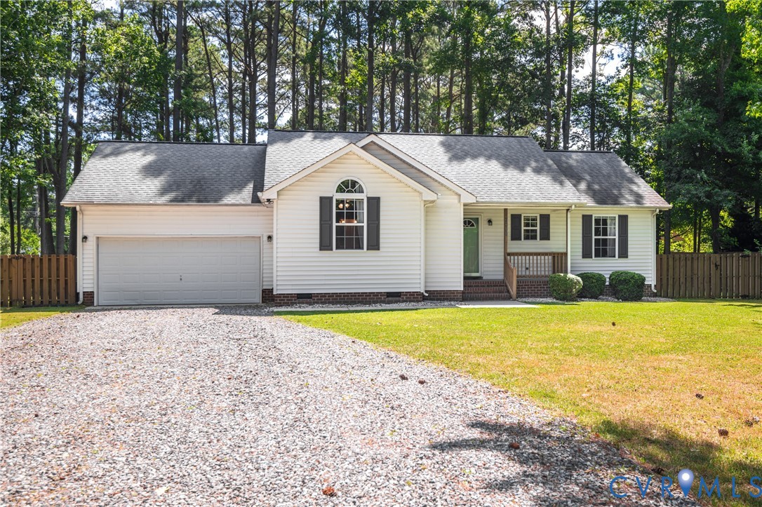 2099 Yacht Club Road Hayes, VA 23072 - Photo 4 of 42 a front view of a house with a yard and garage