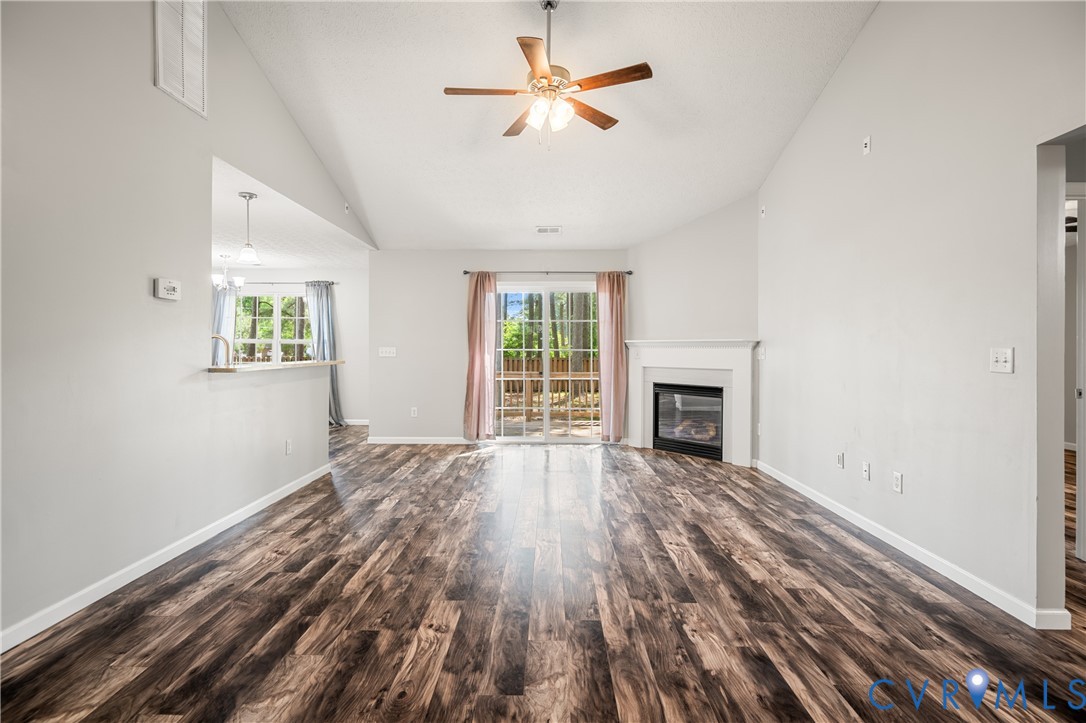 2099 Yacht Club Road Hayes, VA 23072 - Photo 7 of 42 wooden floor fireplace and windows in an empty room