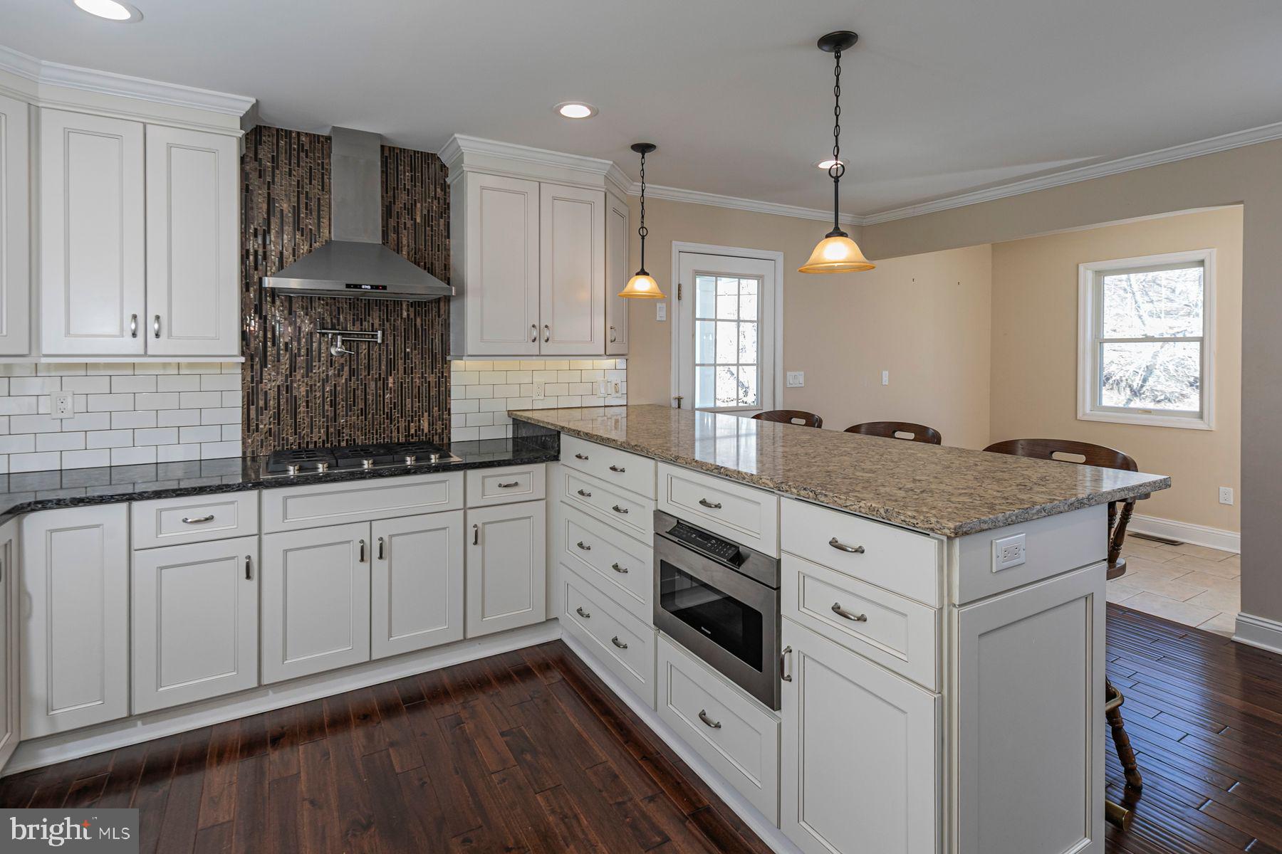 310 Hollow Road Skillman, NJ 08558 - Photo 11 of 32 a kitchen with granite countertop cabinets stainless steel appliances and a wooden floor