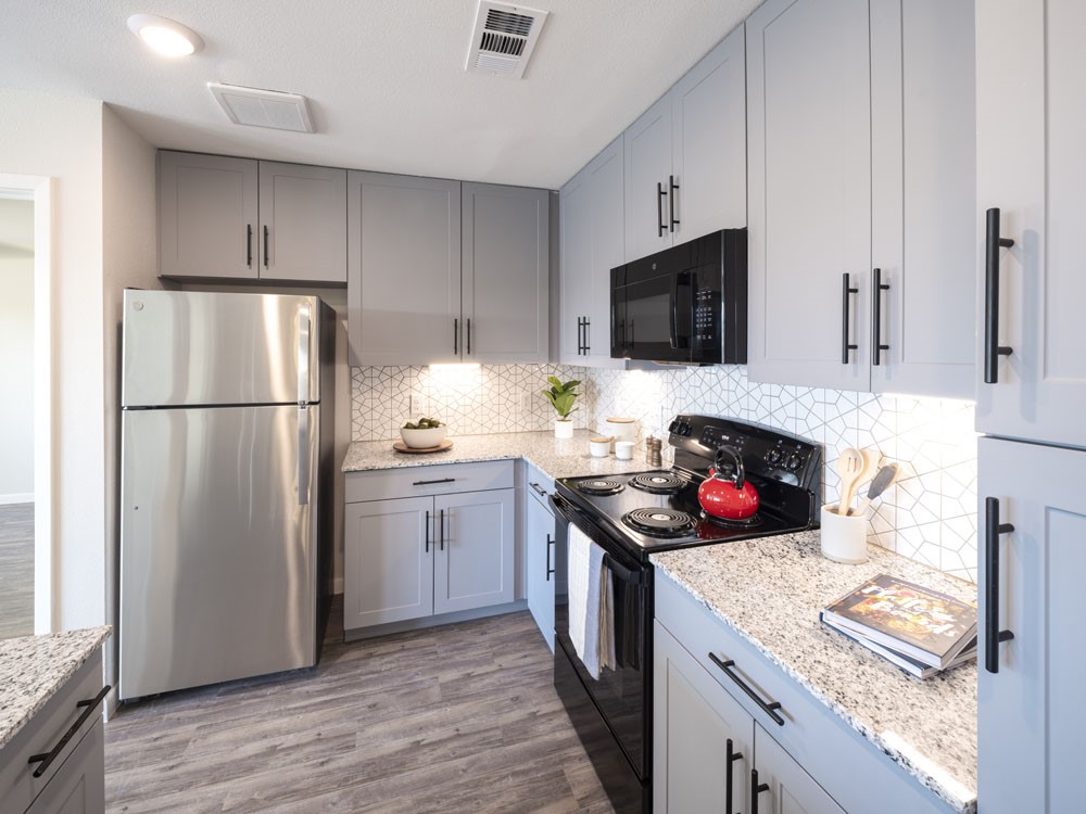 4611 North Interstate 35 Frontage Road Austin, TX 78722 - Photo 6 of 11 a kitchen with stainless steel appliances a stove refrigerator and microwave