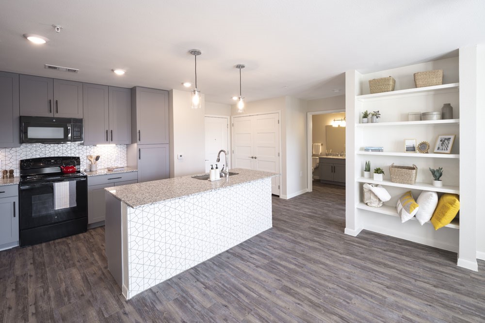 4611 North Interstate 35 Frontage Road Austin, TX 78722 - Photo 8 of 11 a large kitchen with kitchen island a stove a sink a refrigerator and a cabinets