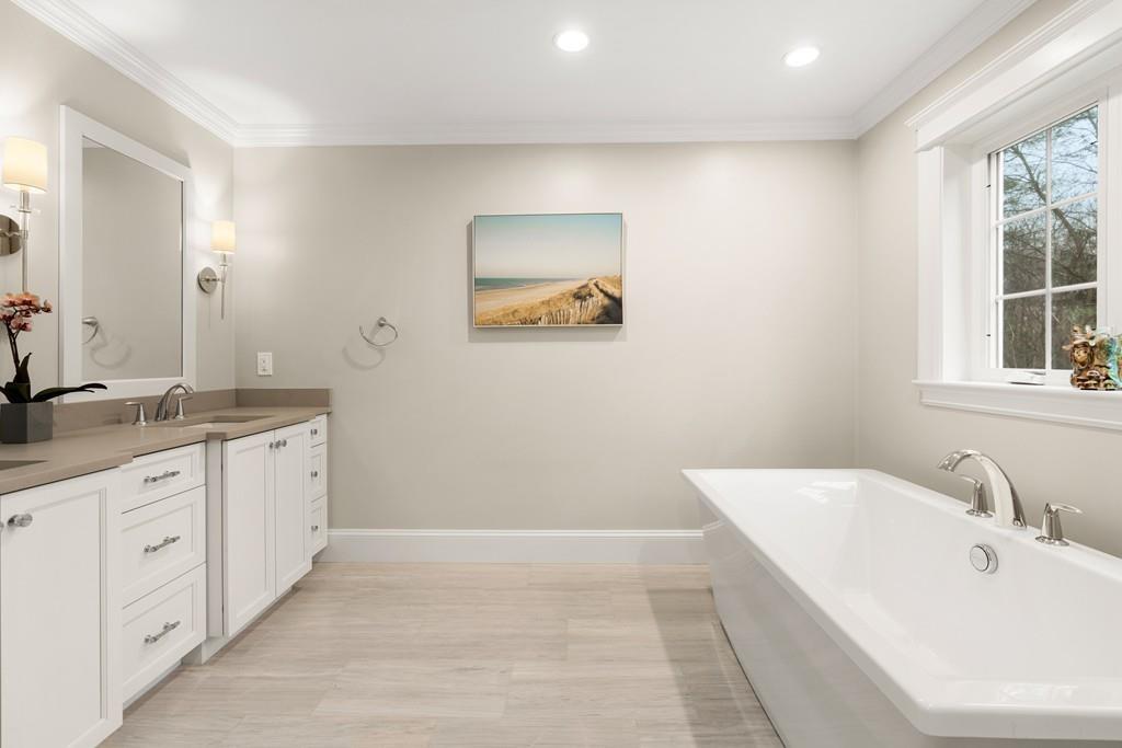 18 Webb Avenue Wellesley, MA 02481 - Photo 12 of 19 a spacious bathroom with a granite countertop sink a mirror and a bathtub