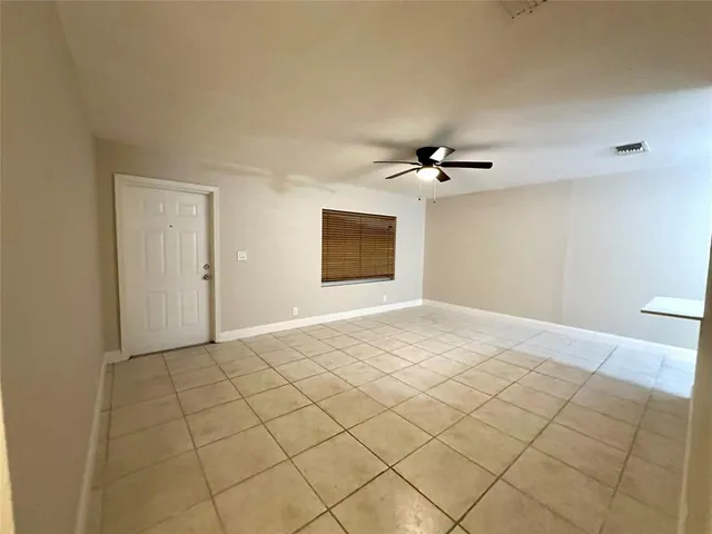 a view of a livingroom with a ceiling fan and window