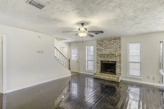 wooden floor in an empty room with a fireplace