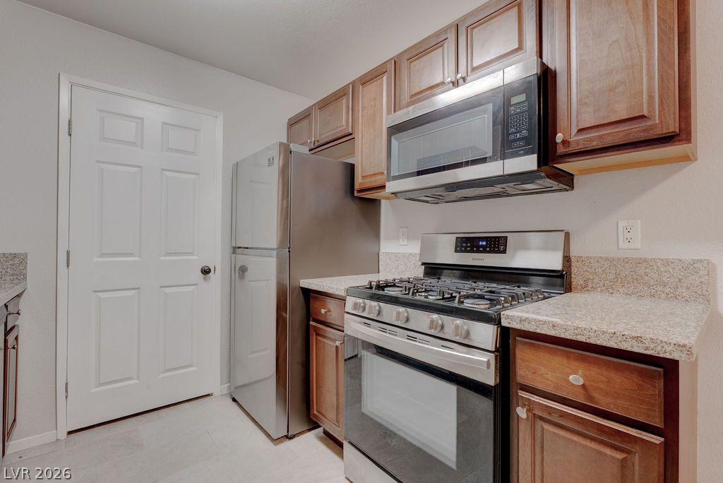 7885 West Flamingo Road, Unit 1016 Las Vegas, NV 89147 - Photo 11 of 24 A compact kitchen with sleek stainless steel appliances and ample cabinetry.