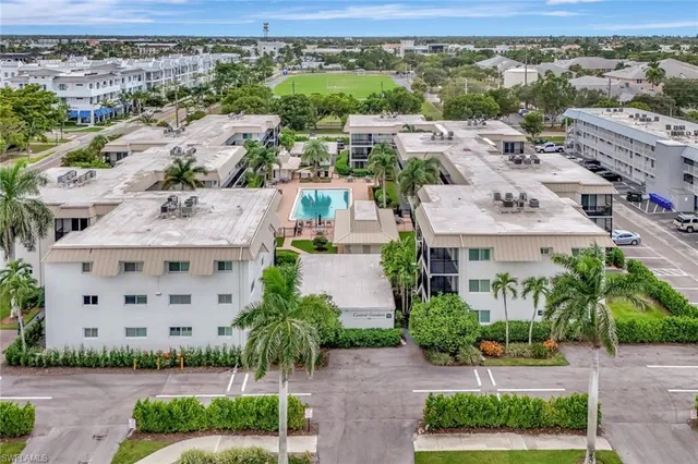an aerial view of residential houses with green space