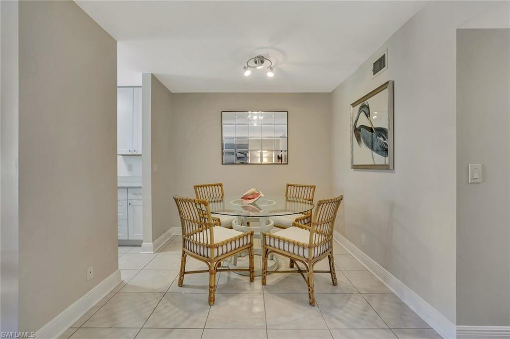 766 Central Avenue, Unit 304 Naples, FL 34102 - Photo 12 of 29 a view of a dining room with furniture