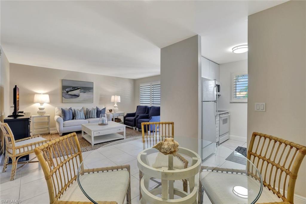 766 Central Avenue, Unit 304 Naples, FL 34102 - Photo 13 of 29 a living room with furniture and a wooden floor