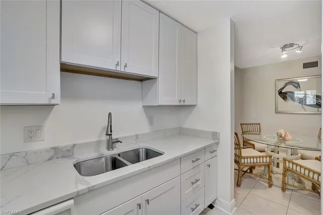 a kitchen with white cabinets and a sink