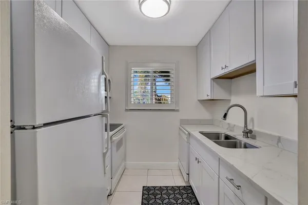a kitchen with stainless steel appliances a refrigerator sink and cabinets