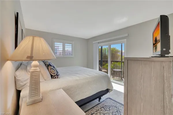a bedroom with a bed lamp and window