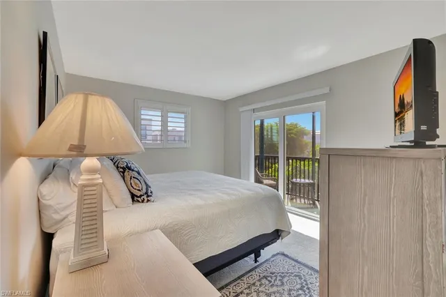 a bedroom with a bed lamp and window