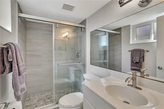 a bathroom with a sink toilet and shower