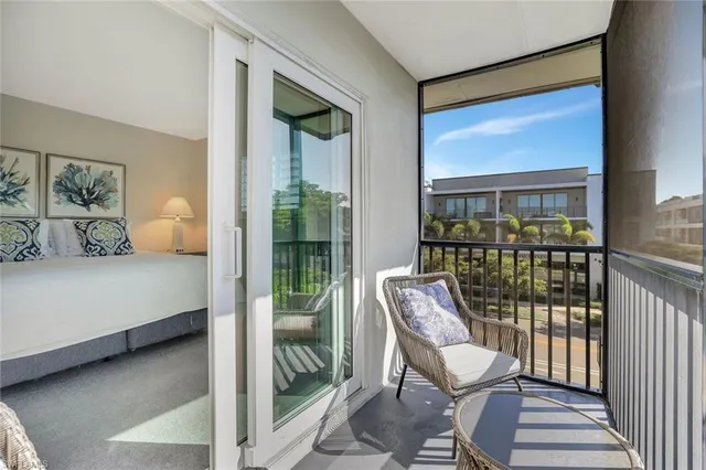 a bedroom with a bed and glass door