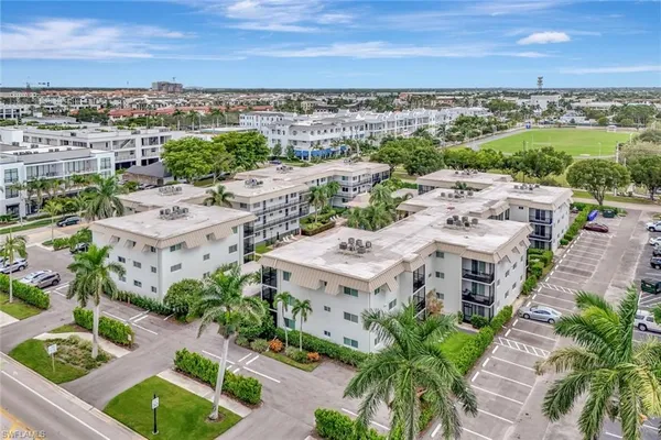 an aerial view of residential building with green space