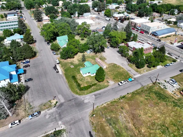 an aerial view of a house with a yard and greenery