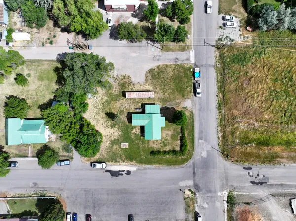 an aerial view of a house with a yard and large trees