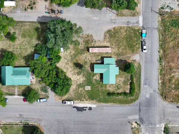 an aerial view of a house with a yard and tree s