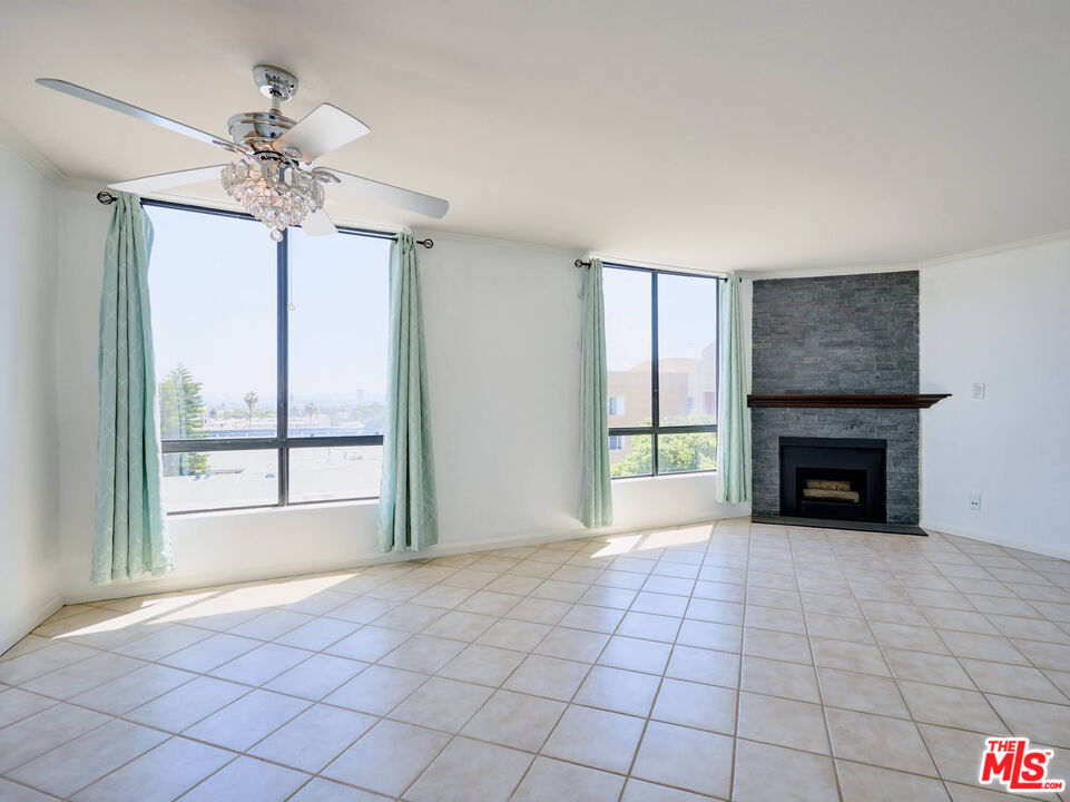 7320 Hawthorn Avenue, Unit 222 Los Angeles, CA 90046 - Photo 17 of 33 a view of an empty room with a fireplace and a window