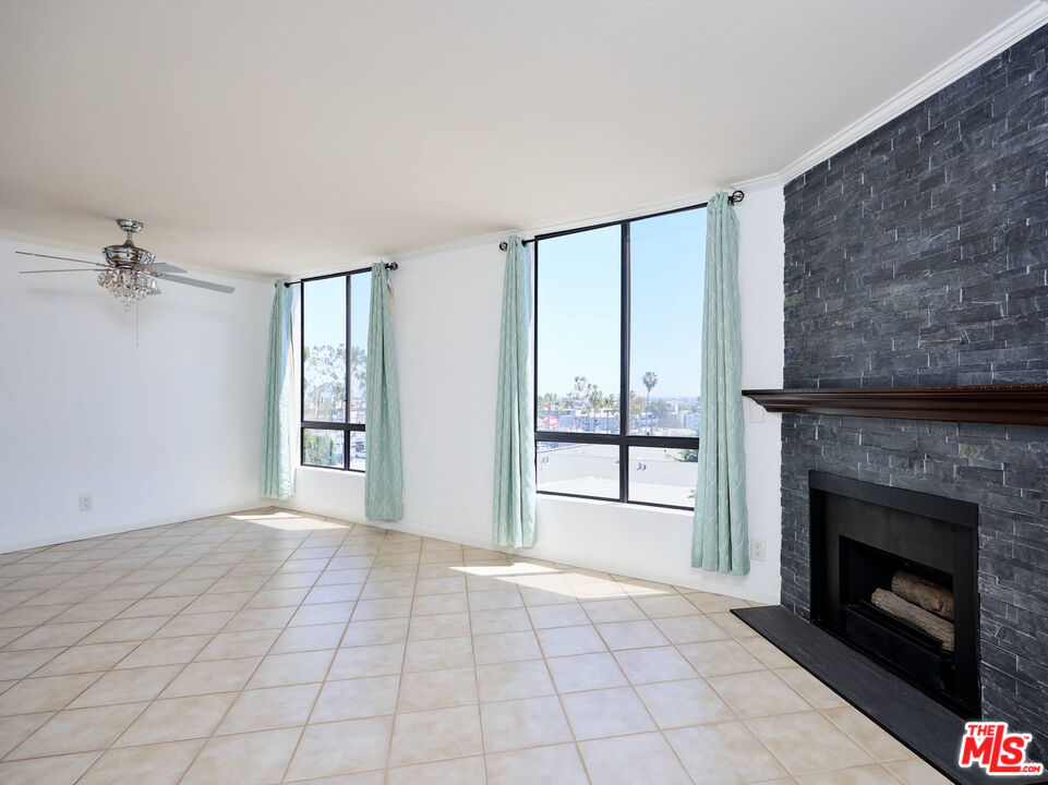 7320 Hawthorn Avenue, Unit 222 Los Angeles, CA 90046 - Photo 18 of 33 a view of an empty room with a fireplace and a window