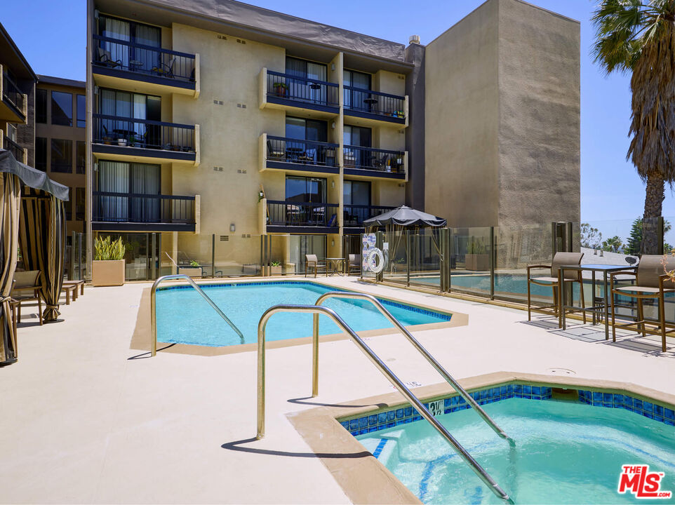 7320 Hawthorn Avenue, Unit 222 Los Angeles, CA 90046 - Photo 31 of 33 a view of swimming pool with a bench and lawn chairs