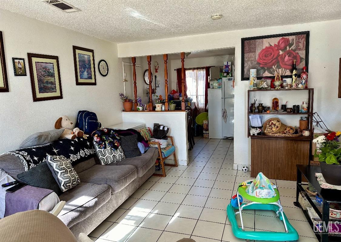 Undisclosed Address Delano, CA 93215 - Photo 2 of 3 a living room with furniture and a couch