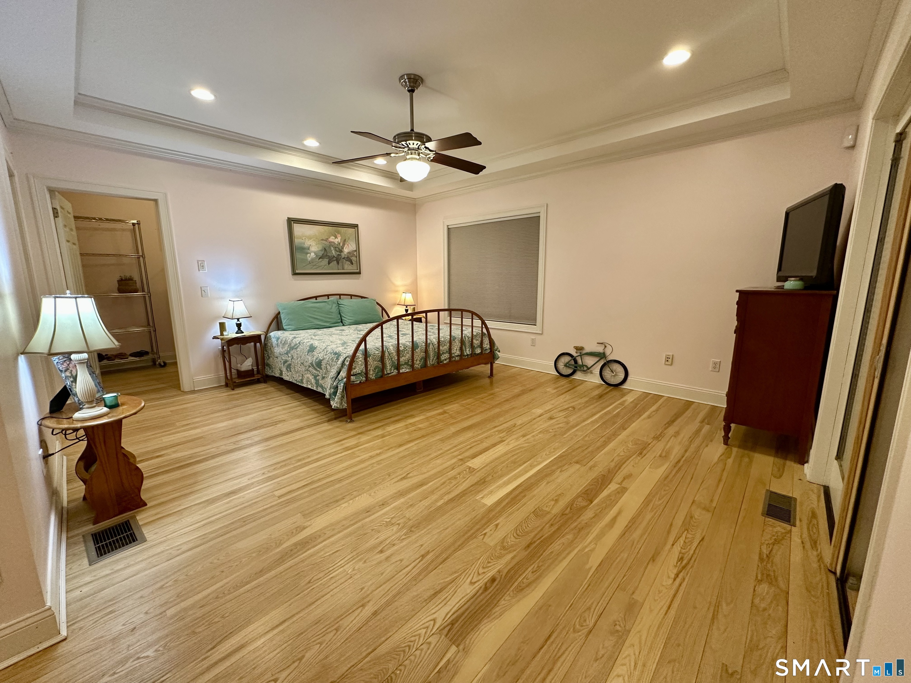 455 Chesterfield Road Montville, CT 06370 - Photo 12 of 40 a bed room with a bed and a chandelier