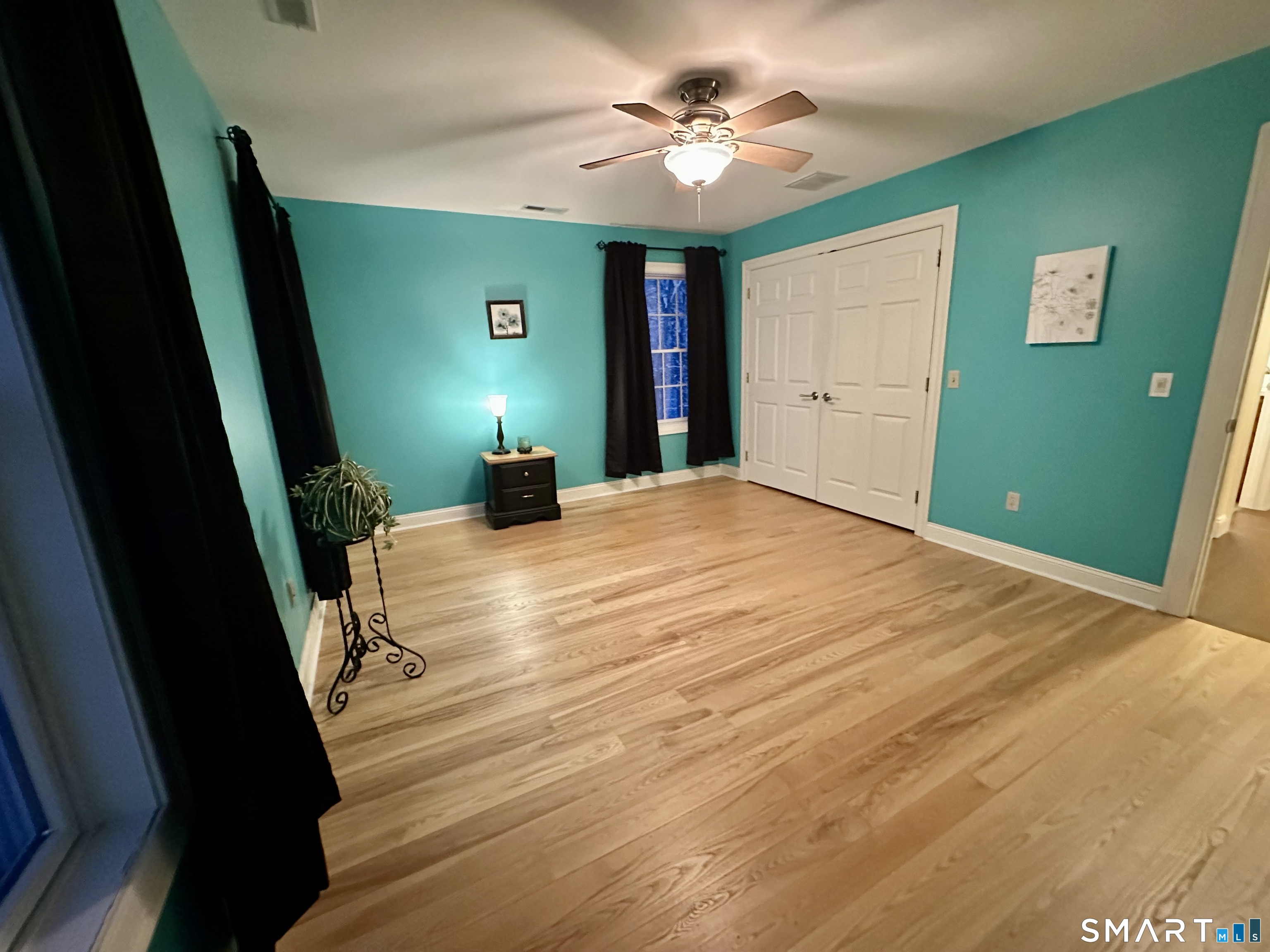 455 Chesterfield Road Montville, CT 06370 - Photo 22 of 40 a bedroom with a bed and a chandelier