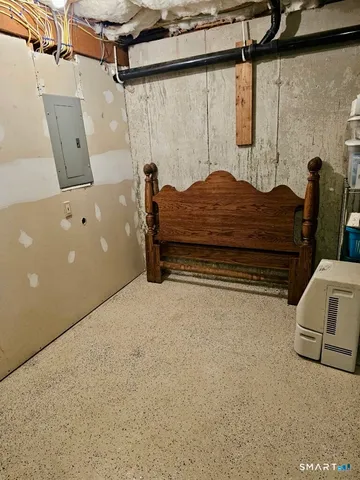 a bedroom with a bed and a chair