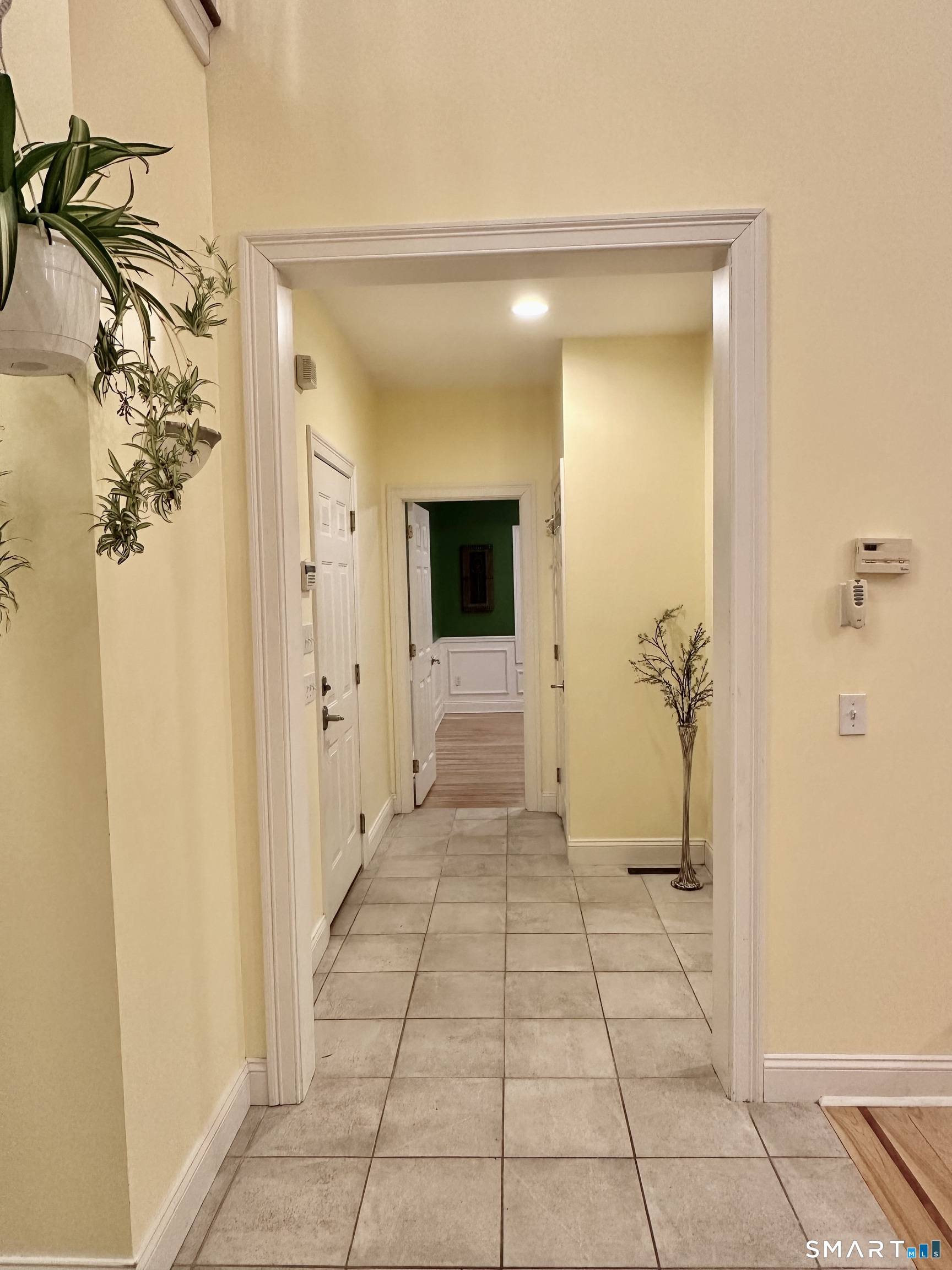 455 Chesterfield Road Montville, CT 06370 - Photo 10 of 40 Standing in Entrance Foyer looking towards Primary Suite Area. Garage Door on Left, Office Straight Ahead, Coat Closet Outside Office & Close to Garage Door. Hallway to Laundry and Primary Bedroom EnSuite to Right.