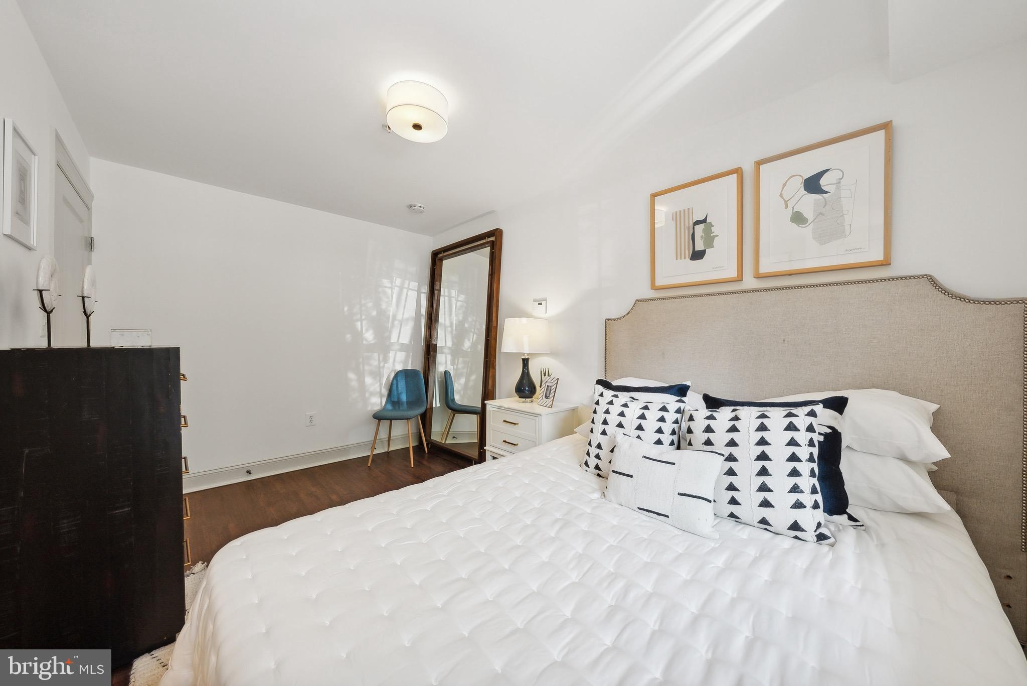 1354 Euclid Street Northwest, Unit 101B Washington, DC 20009 - Photo 11 of 15 a bedroom with a bed and wooden floor
