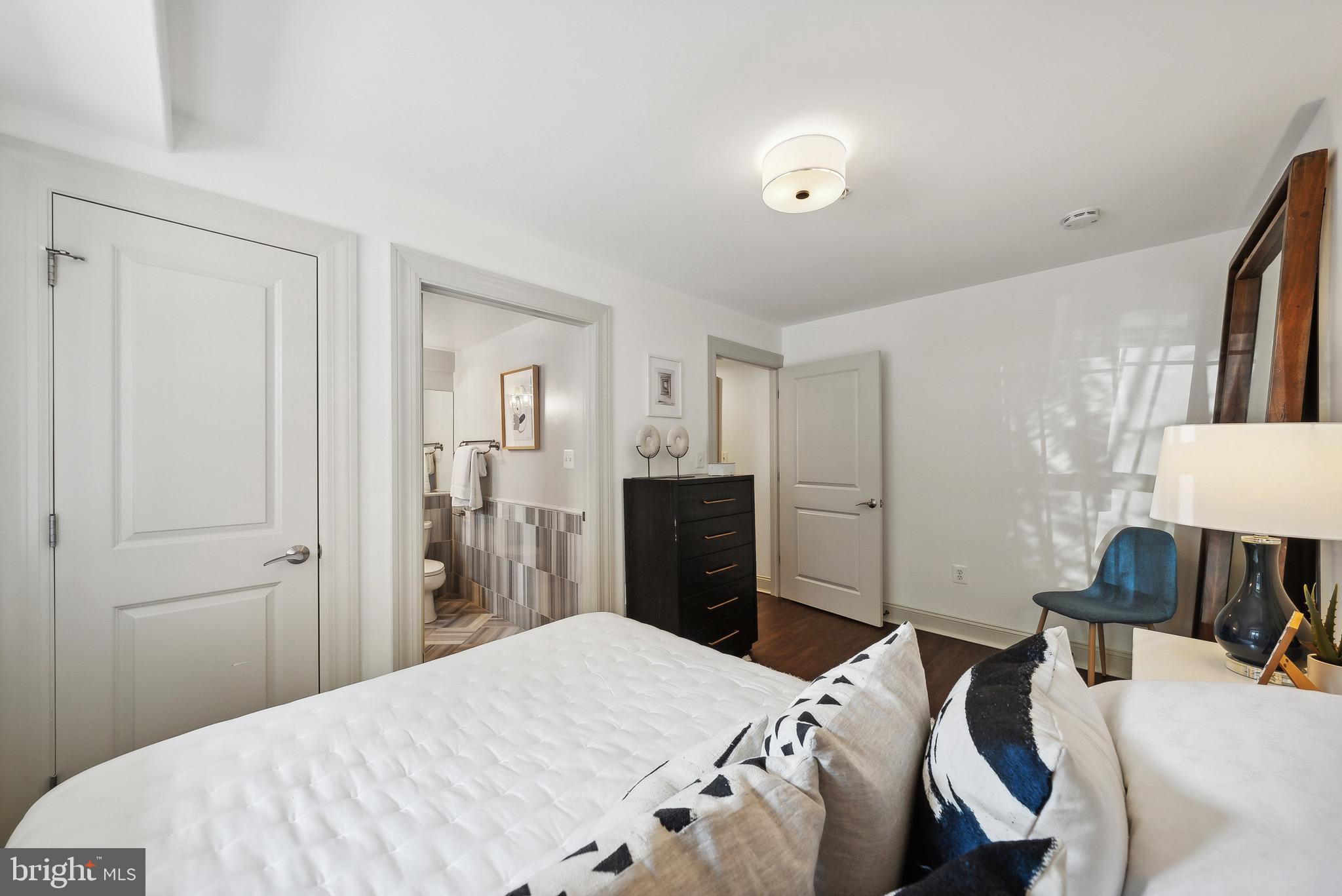 1354 Euclid Street Northwest, Unit 101B Washington, DC 20009 - Photo 12 of 15 a bedroom with a bed and a flat tv screen
