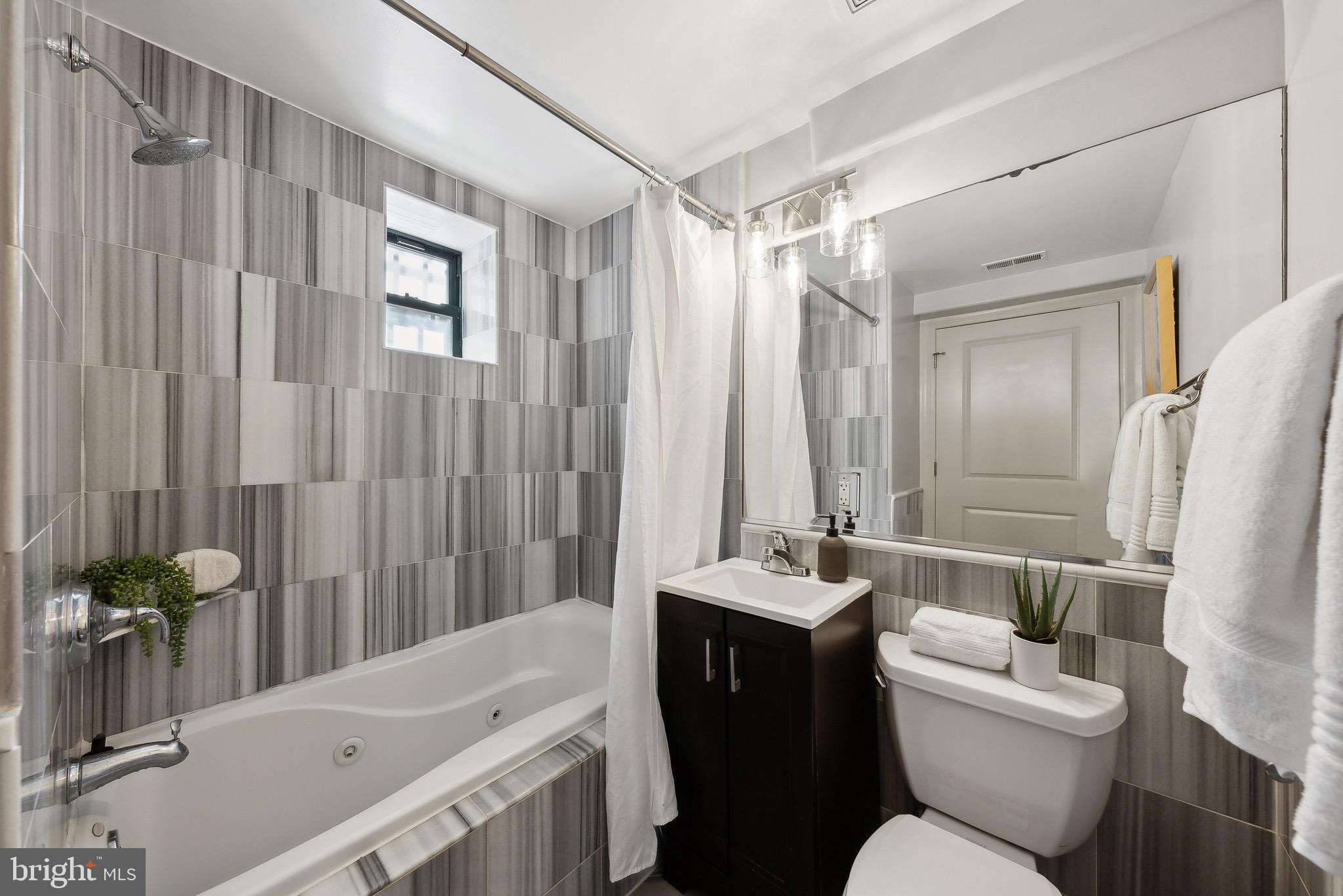 1354 Euclid Street Northwest, Unit 101B Washington, DC 20009 - Photo 13 of 15 a bathroom with a sink toilet and shower