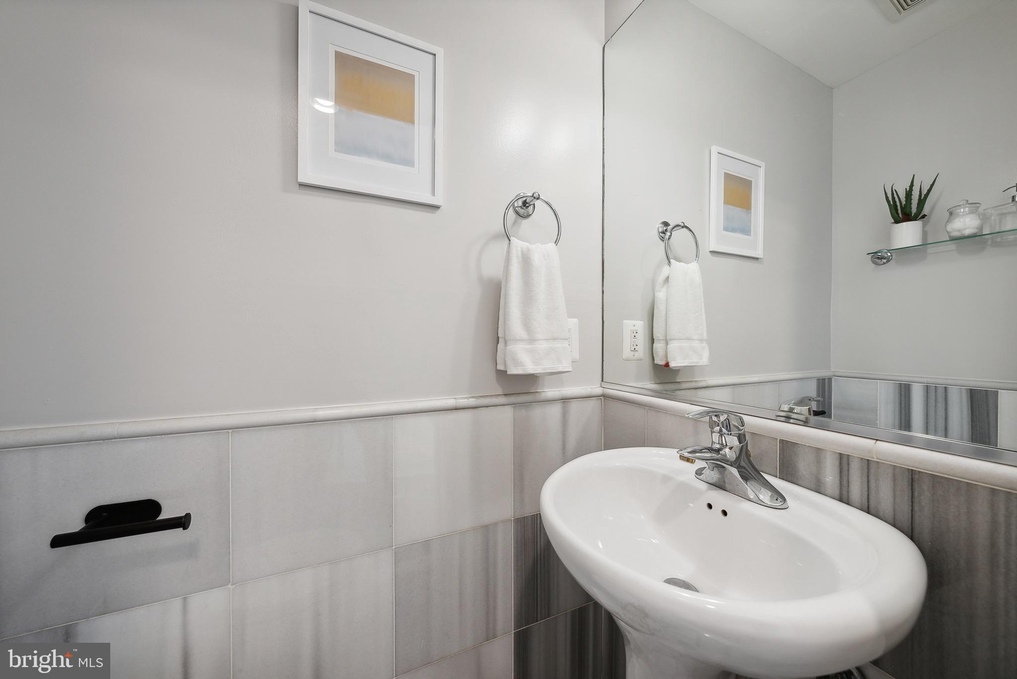 1354 Euclid Street Northwest, Unit 101B Washington, DC 20009 - Photo 9 of 15 a bathroom with a sink and a mirror