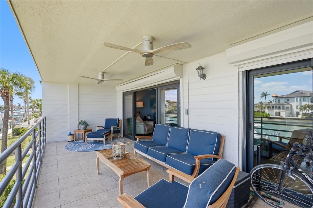 363 Pinellas Bayway South, Unit 29 Tierra Verde, FL 33715 - Photo 35 of 59 a living room with furniture a ceiling fan and a rug
