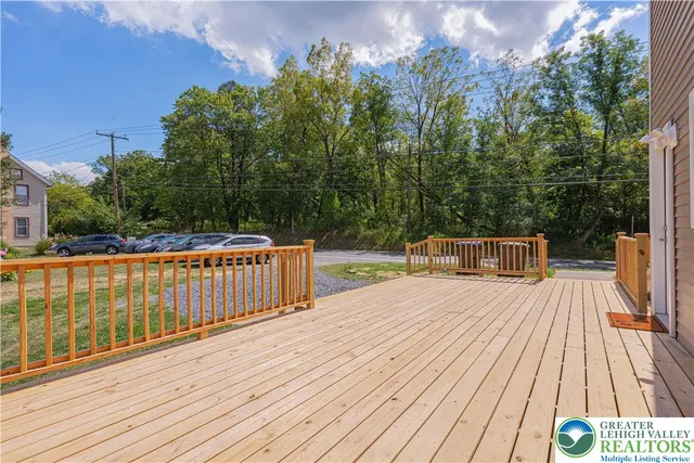 a balcony with wooden floor and fence