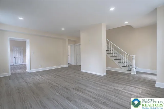 a view of an empty room with wooden floor