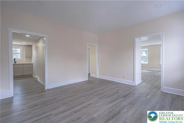 a view of an empty room and wooden floor