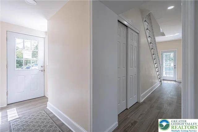a view of hallway with wooden floor