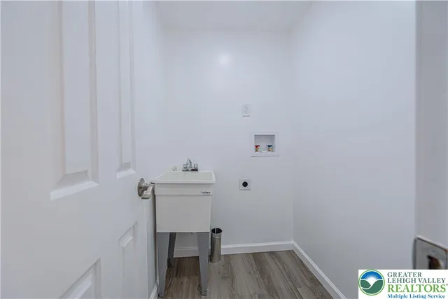 a view of a room with wooden floor and bench