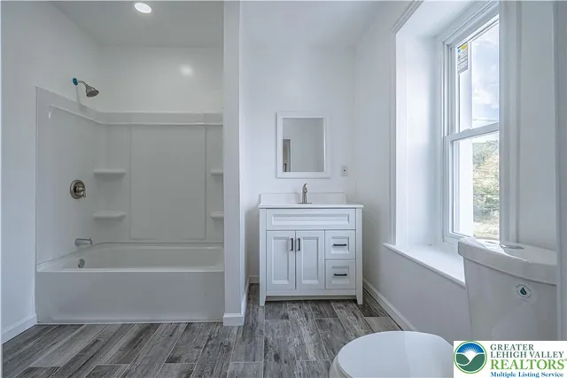 a bathroom with a sink a toilet and bathtub