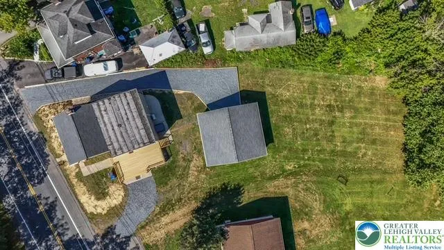 an aerial view of a house with a yard