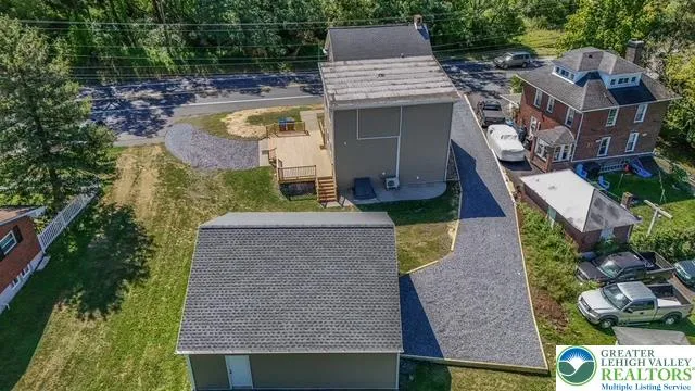 an aerial view of a house with swimming pool garden and patio