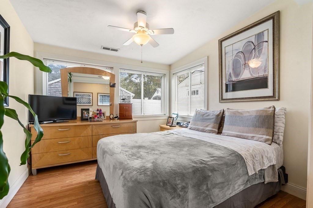 16 Monack Road Wareham, MA 02532 - Photo 12 of 24 a bedroom with a large bed and a chandelier