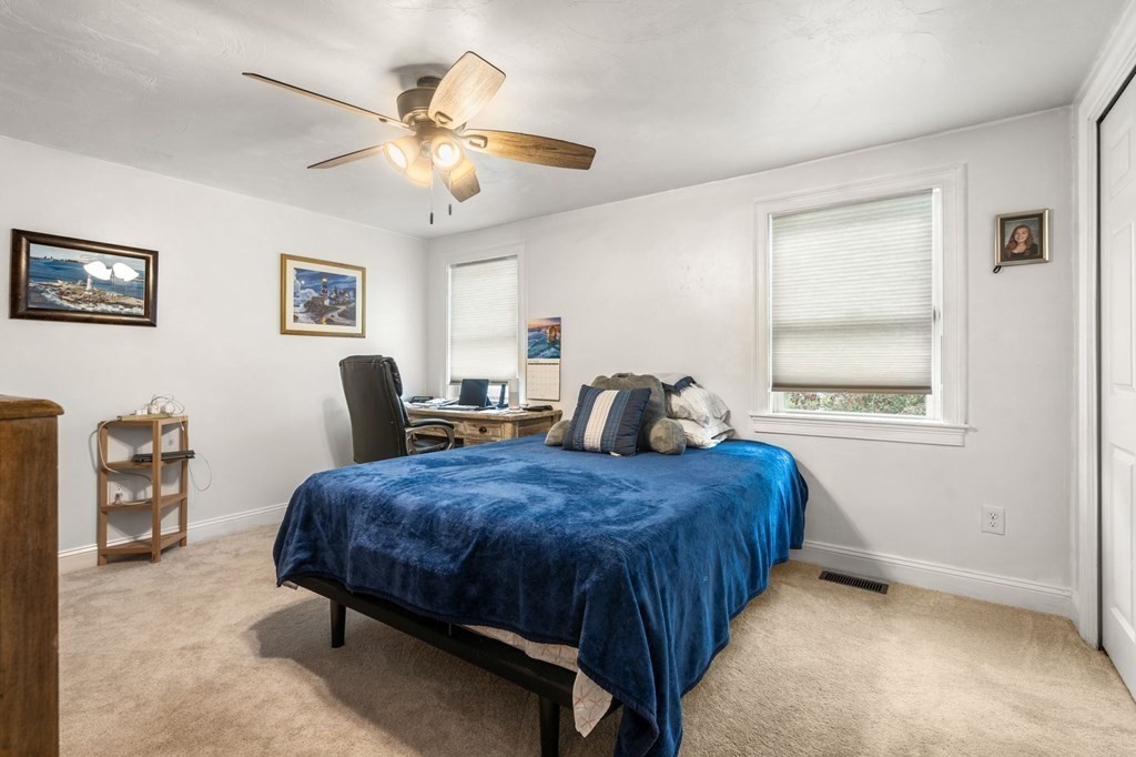 16 Monack Road Wareham, MA 02532 - Photo 14 of 24 a bedroom with a bed and a chandelier