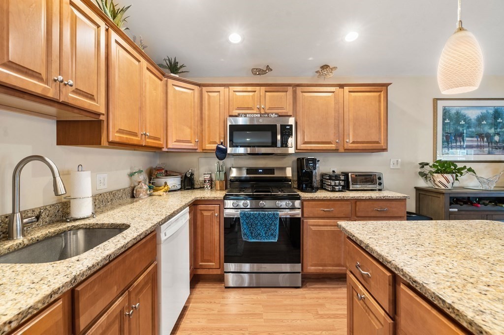 16 Monack Road Wareham, MA 02532 - Photo 8 of 24 a kitchen with stainless steel appliances granite countertop a stove a sink and a microwave