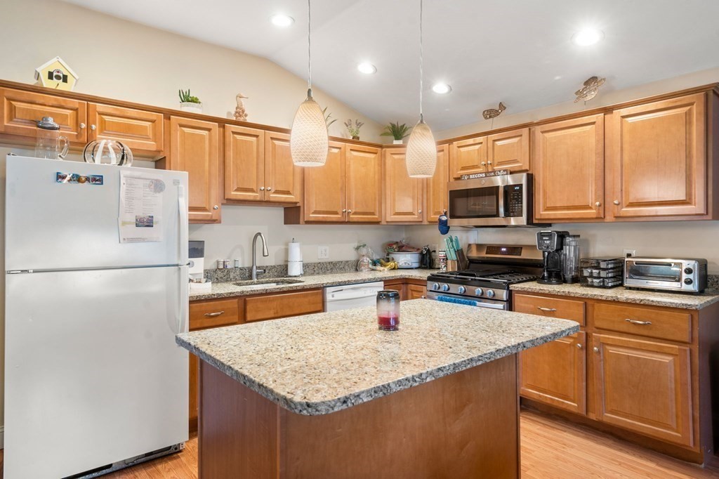 16 Monack Road Wareham, MA 02532 - Photo 9 of 24 a kitchen with stainless steel appliances granite countertop a refrigerator a sink a stove a microwave and cabinets