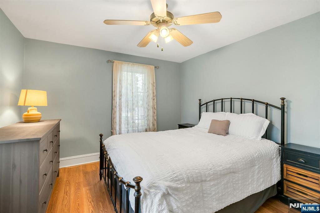 409 Warren Avenue Ho-Ho-Kus, NJ 07423 - Photo 11 of 23 a bedroom with a bed and a chandelier