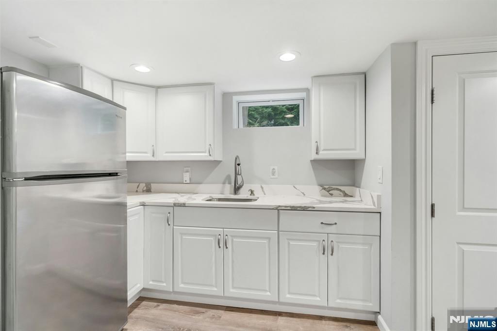 409 Warren Avenue Ho-Ho-Kus, NJ 07423 - Photo 17 of 23 a kitchen with white cabinets and sink
