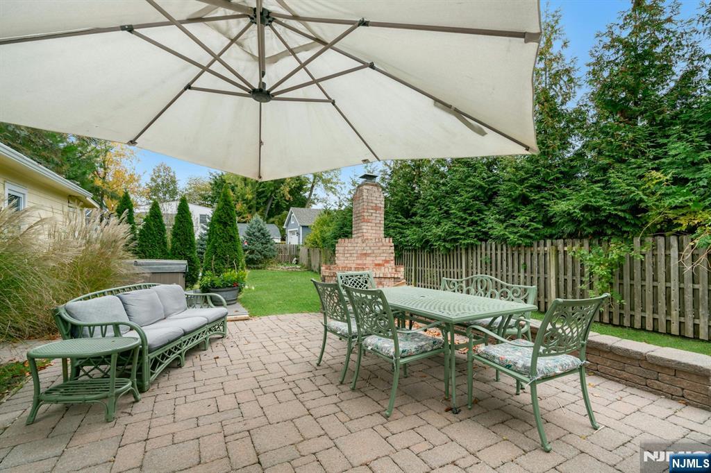 409 Warren Avenue Ho-Ho-Kus, NJ 07423 - Photo 18 of 23 a patio with a patio table and chairs